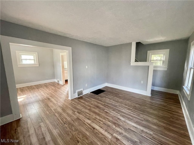1072 Pitkin Ave, Akron, OH 44310 - spare room featuring a textured ceiling and dark wood-style floors