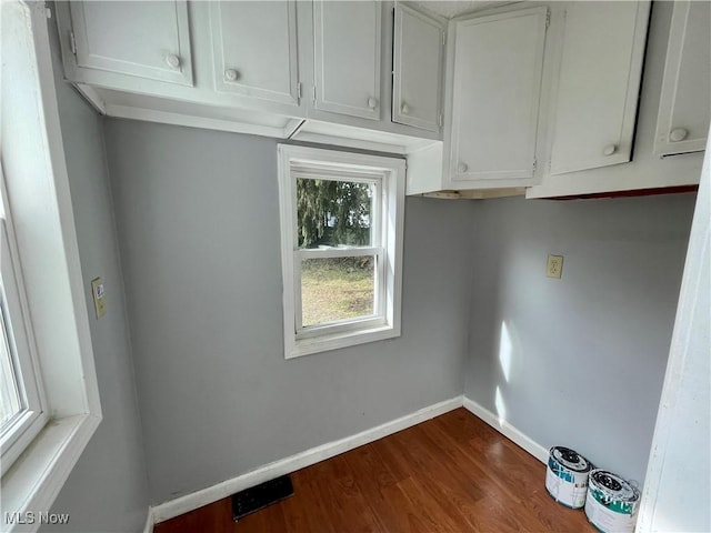 1072 Pitkin Ave, Akron, OH 44310 - laundry room with dark wood-style floors and baseboards