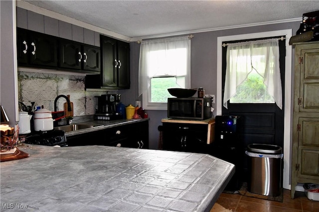 1511 Lake Front Dr, Salem, OH 44460 - kitchen featuring stainless steel microwave, ornamental molding, a textured ceiling, and tile counters