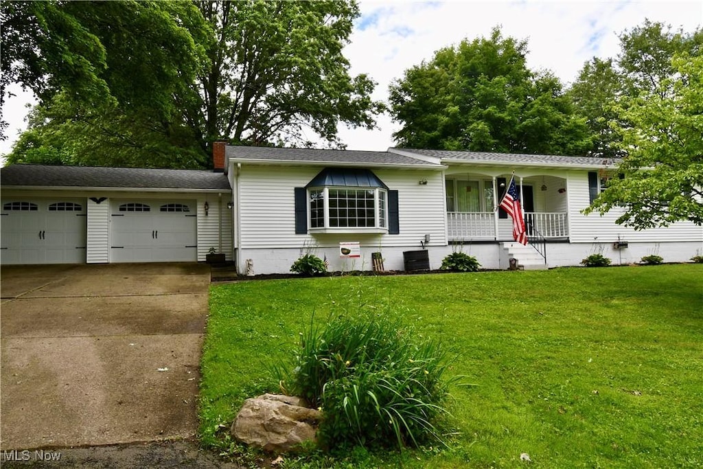 29485 Valleyview Ct, Salem, OH 44460 - ranch-style home featuring a porch, an attached garage, concrete driveway, a front yard, and a chimney