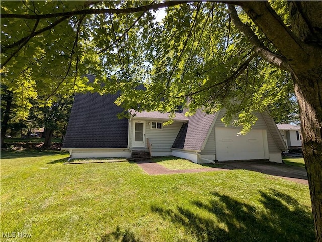 10247 Smugglers Cv, Reminderville, OH 44202 - a-frame home with entry steps, asphalt driveway, roof with shingles, a front yard, and an attached garage