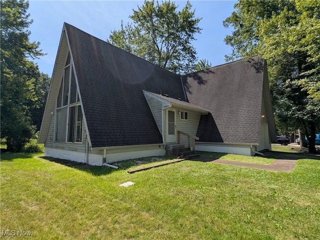 10247 Smugglers Cv, Reminderville, OH 44202 - view of property exterior with entry steps, a lawn, and a shingled roof