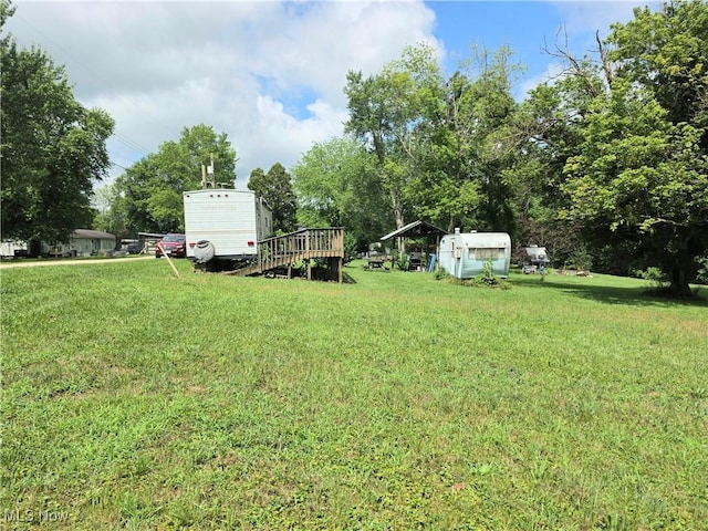 99 E Apple Blossom Way, Elizabeth, WV 26143 - view of green lawn with a storage unit and a deck