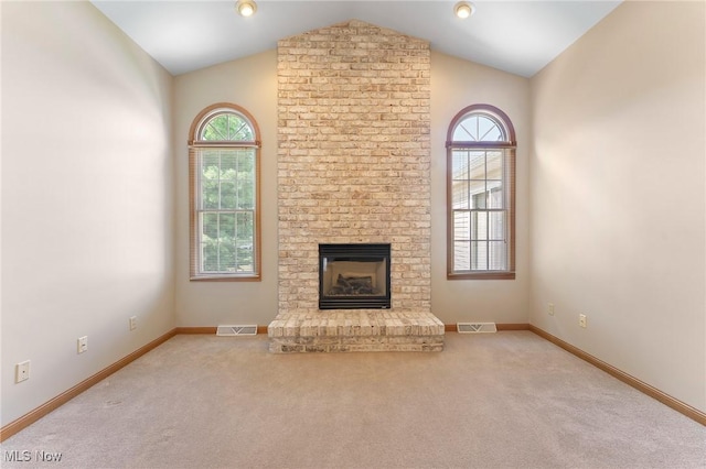 7900 Walnut St Unit 10, Boardman, OH 44512 - unfurnished living room featuring healthy amount of natural light, carpet floors, vaulted ceiling, and a fireplace