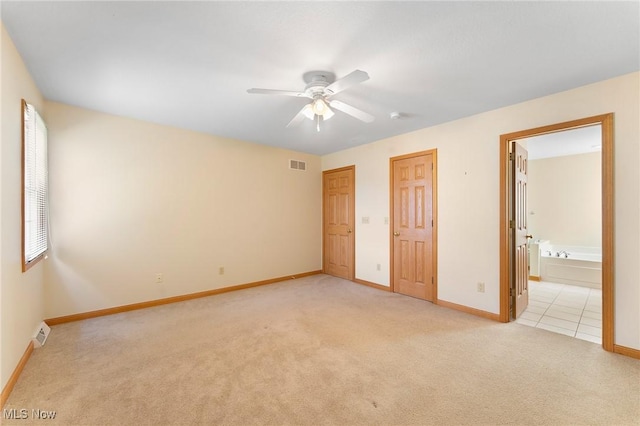 7900 Walnut St Unit 10, Boardman, OH 44512 - unfurnished bedroom with light carpet, ensuite bathroom, and ceiling fan