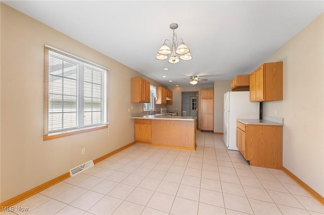 7900 Walnut St Unit 10, Boardman, OH 44512 - kitchen with a peninsula, a chandelier, freestanding refrigerator, plenty of natural light, and recessed lighting