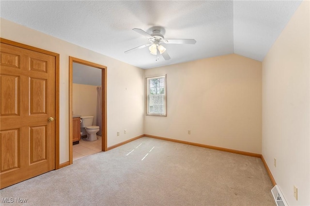 7900 Walnut St Unit 10, Boardman, OH 44512 - unfurnished bedroom featuring light carpet, vaulted ceiling, ensuite bath, and a ceiling fan