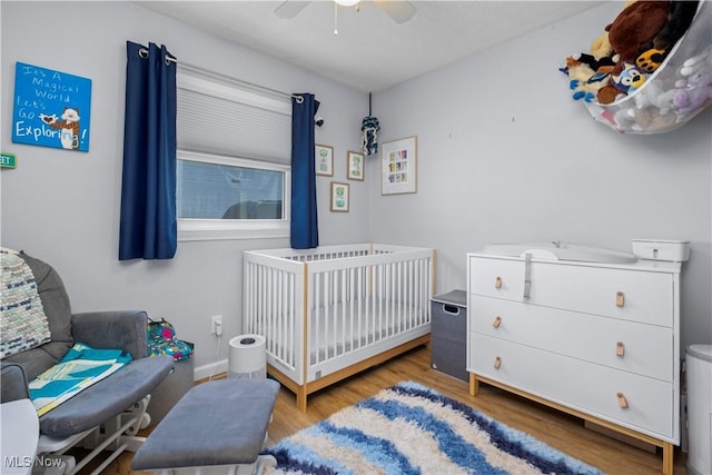 1921 Adrian Cir, Sandusky, OH 44870 - bedroom featuring wood finished floors, a nursery area, and a ceiling fan