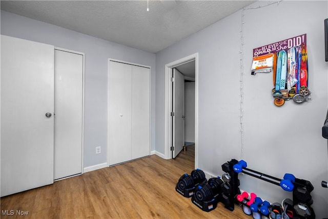 1921 Adrian Cir, Sandusky, OH 44870 - unfurnished bedroom featuring wood finished floors, a textured ceiling, and a ceiling fan