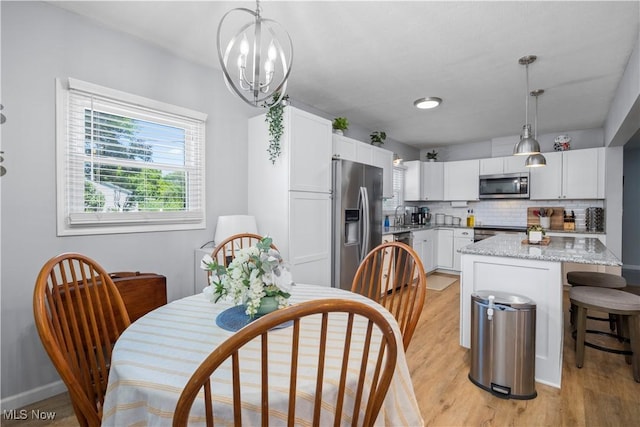 1921 Adrian Cir, Sandusky, OH 44870 - kitchen featuring stainless steel appliances, light wood-type flooring, white cabinets, decorative backsplash, and light stone countertops
