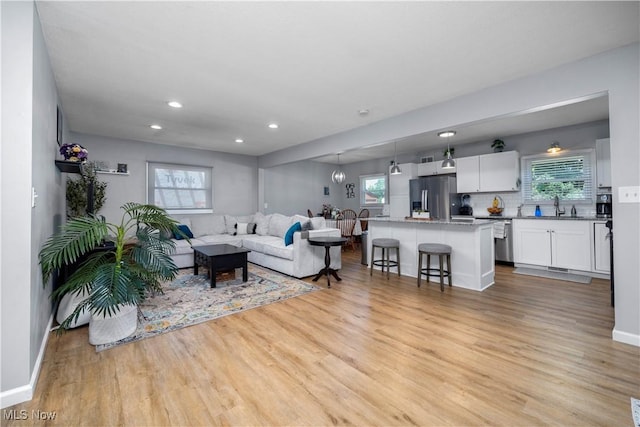 1921 Adrian Cir, Sandusky, OH 44870 - living area featuring light wood-style floors and recessed lighting