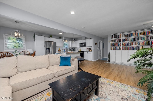 1921 Adrian Cir, Sandusky, OH 44870 - living room featuring light wood-style floors, a chandelier, and recessed lighting