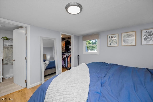 1921 Adrian Cir, Sandusky, OH 44870 - bedroom featuring a spacious closet, light wood-style floors, a closet, and ensuite bathroom