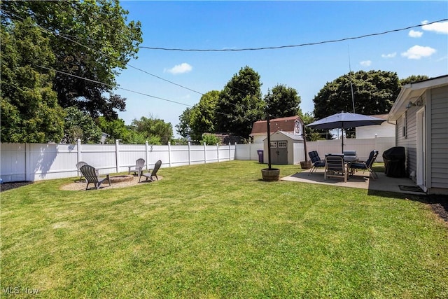 1921 Adrian Cir, Sandusky, OH 44870 - fenced backyard featuring a storage shed, an outdoor fire pit, and a patio
