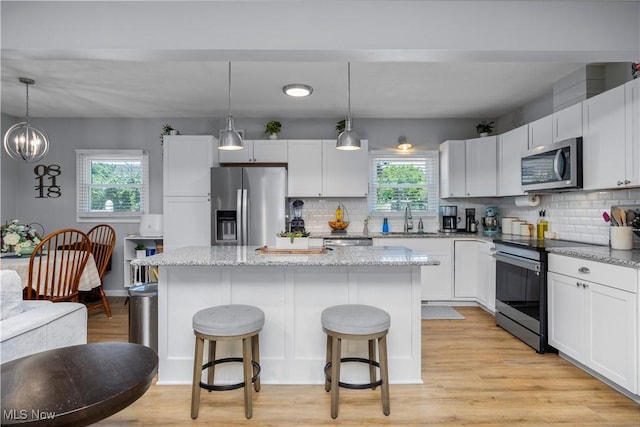 1921 Adrian Cir, Sandusky, OH 44870 - kitchen with appliances with stainless steel finishes, healthy amount of natural light, a center island, and a breakfast bar