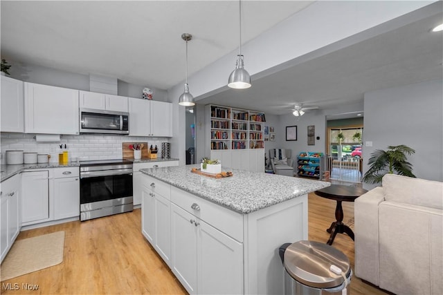 1921 Adrian Cir, Sandusky, OH 44870 - kitchen with appliances with stainless steel finishes, light wood-style flooring, open floor plan, and a center island
