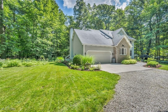 949 S Medina Line Rd, Wadsworth, OH 44281 - view of front of property with concrete driveway, a garage, a front yard, a chimney, and brick siding