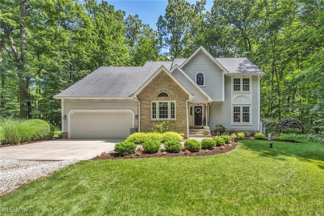 949 S Medina Line Rd, Wadsworth, OH 44281 - traditional home with concrete driveway, an attached garage, brick siding, a front lawn, and roof with shingles