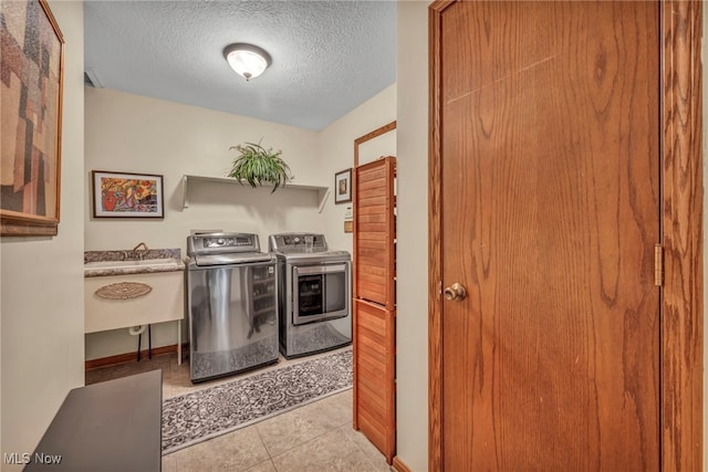 949 S Medina Line Rd, Wadsworth, OH 44281 - laundry room with washing machine and dryer, a textured ceiling, and light tile patterned floors