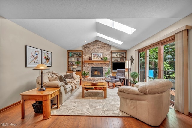 949 S Medina Line Rd, Wadsworth, OH 44281 - living room with a skylight, vaulted ceiling, hardwood / wood-style floors, a brick fireplace, and built in shelves