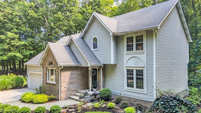 949 S Medina Line Rd, Wadsworth, OH 44281 - view of front of property with a garage, a shingled roof, concrete driveway, brick siding, and view of scattered trees