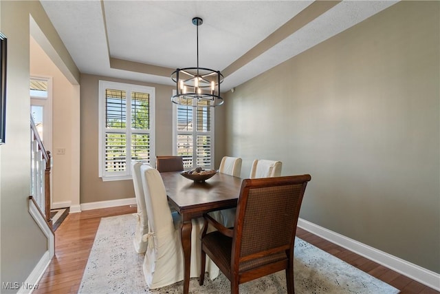 4276 Brownstone Ln, Medina, OH 44256 - dining area with light wood-style flooring, a chandelier, and a tray ceiling