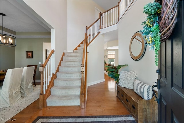 4276 Brownstone Ln, Medina, OH 44256 - entryway featuring wood finished floors, stairway, and a chandelier