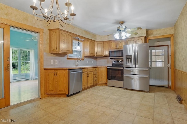 662 Beech Ave, Youngstown, OH 44512 - kitchen with appliances with stainless steel finishes, ceiling fan, light countertops, light floors, and a chandelier
