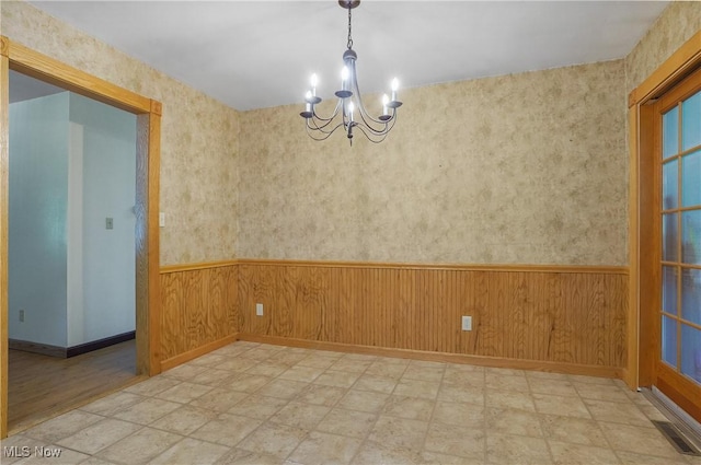 662 Beech Ave, Youngstown, OH 44512 - spare room featuring a chandelier, a wainscoted wall, and wooden walls