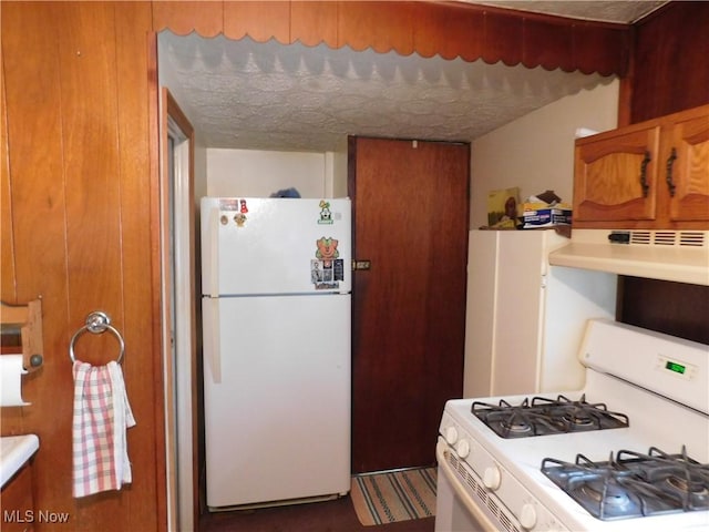 30051 Regent Rd, Wickliffe, OH 44092 - kitchen featuring white appliances, ventilation hood, brown cabinets, and light countertops