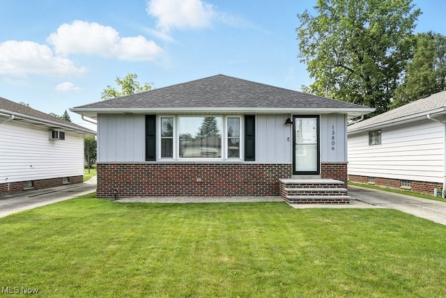 13806 Carpenter Rd, Garfield Heights, OH 44125 - bungalow-style house with board and batten siding and a front lawn