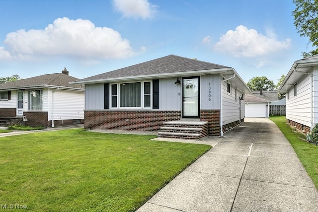 13806 Carpenter Rd, Garfield Heights, OH 44125 - bungalow-style home featuring board and batten siding, an outbuilding, a front yard, and a detached garage