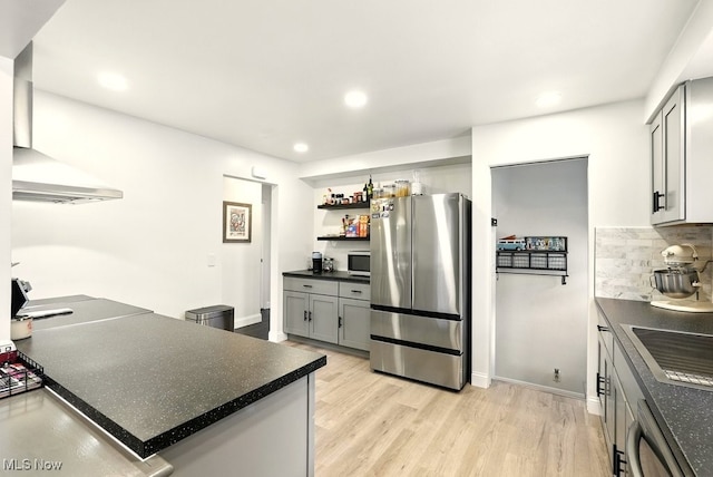 13806 Carpenter Rd, Garfield Heights, OH 44125 - kitchen with appliances with stainless steel finishes, dark countertops, light wood finished floors, recessed lighting, and decorative backsplash