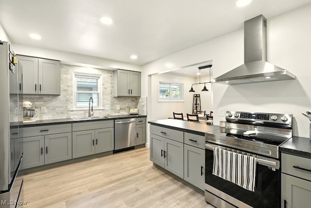 13806 Carpenter Rd, Garfield Heights, OH 44125 - kitchen with stainless steel appliances, wall chimney exhaust hood, dark countertops, gray cabinetry, and tasteful backsplash