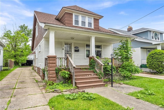 3670 E 138th St, Cleveland, OH 44120 - bungalow-style house featuring a porch and a shingled roof