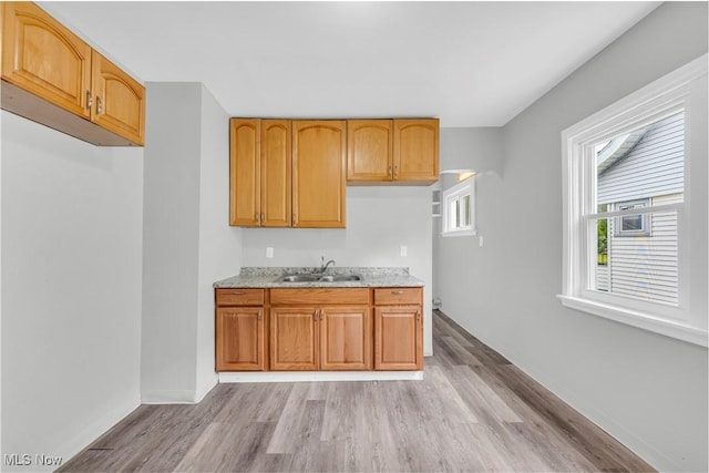 3670 E 138th St, Cleveland, OH 44120 - kitchen featuring light wood finished floors and light stone counters