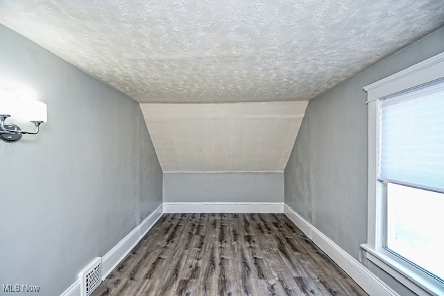 1628 Clark Ave SW, Canton, OH 44706 - additional living space featuring a textured ceiling, wood finished floors, and lofted ceiling