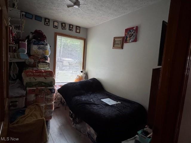 5919 N Bend Rd, Ashtabula, OH 44004 - bedroom featuring a textured ceiling and hardwood / wood-style flooring