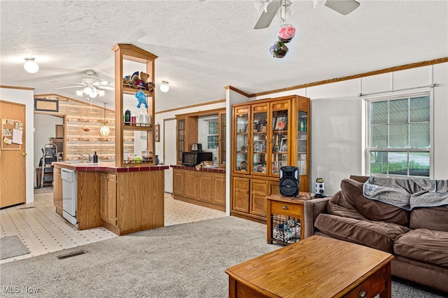 11 Brookins Dr, Olmsted Twp, OH 44138 - kitchen featuring ceiling fan, open floor plan, tile countertops, lofted ceiling, and light carpet