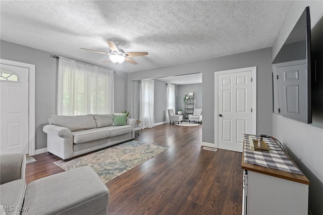 1500 Furnace St, Mineral Ridge, OH 44440 - living room featuring healthy amount of natural light, a ceiling fan, dark wood-style floors, and a textured ceiling