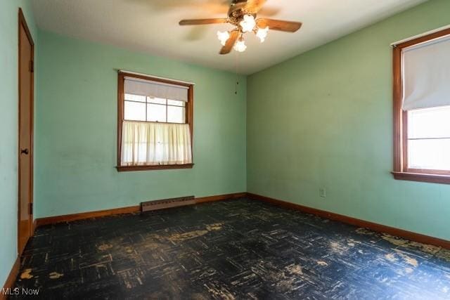 427 E 275th St, Euclid, OH 44132 - unfurnished room with plenty of natural light, a ceiling fan, and a baseboard radiator