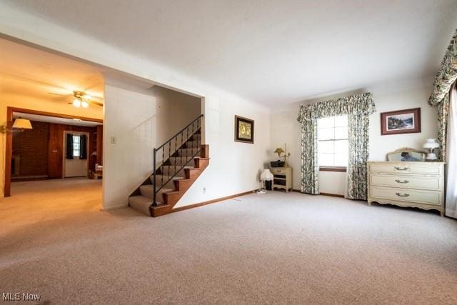 427 E 275th St, Euclid, OH 44132 - carpeted living area featuring stairway and a ceiling fan
