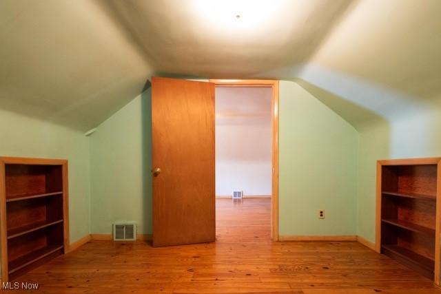 427 E 275th St, Euclid, OH 44132 - additional living space featuring wood finished floors and vaulted ceiling