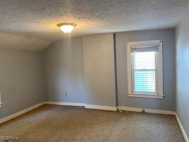 911 32nd St, Parkersburg, WV 26104 - carpeted spare room with a textured ceiling and vaulted ceiling