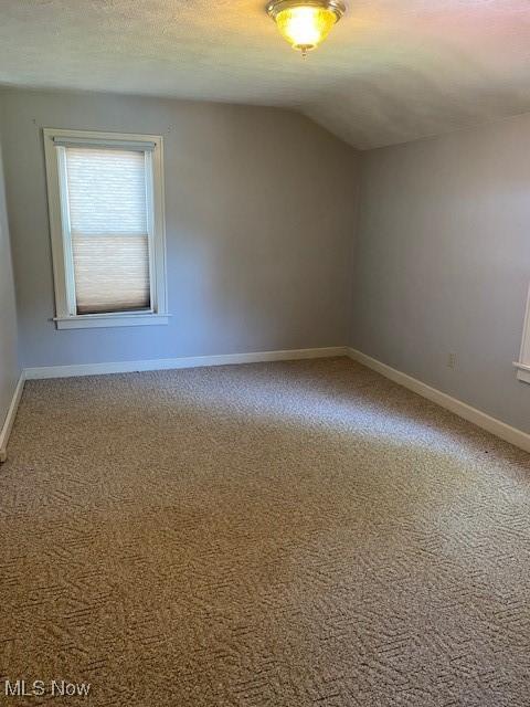 911 32nd St, Parkersburg, WV 26104 - spare room with carpet and lofted ceiling
