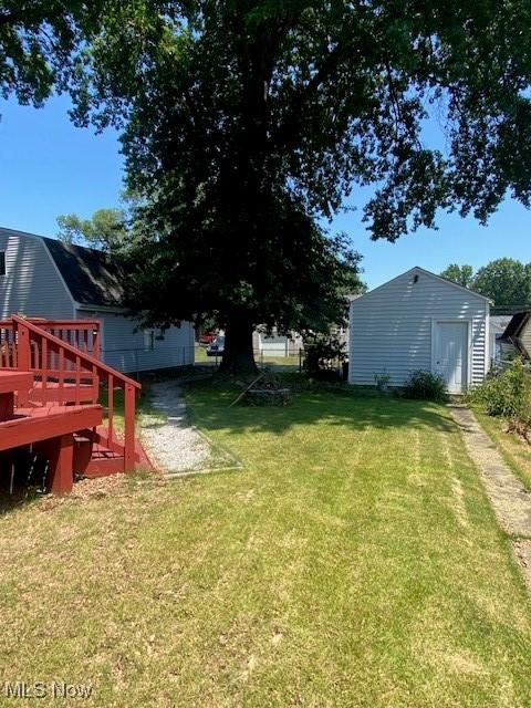 911 32nd St, Parkersburg, WV 26104 - view of green lawn featuring a deck and an outdoor structure