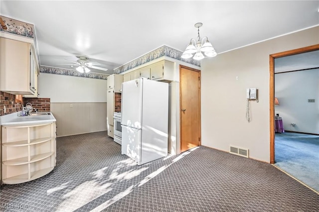 1808 Depot Rd, Salem, OH 44460 - kitchen featuring freestanding refrigerator, carpet, a chandelier, ceiling fan, and cream cabinetry