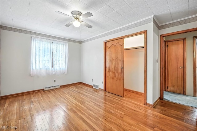 1808 Depot Rd, Salem, OH 44460 - unfurnished bedroom with light wood-style floors, a closet, a ceiling fan, and a baseboard radiator