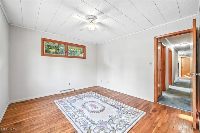 1808 Depot Rd, Salem, OH 44460 - unfurnished room featuring a baseboard heating unit, hardwood / wood-style floors, a ceiling fan, and crown molding