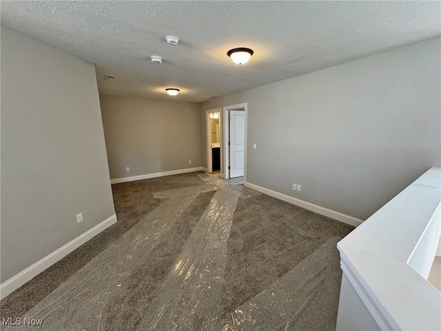 32054 Tuscan Ln Unit L-2, Avon Lake, OH 44012 - carpeted empty room with a smoke detector and a textured ceiling